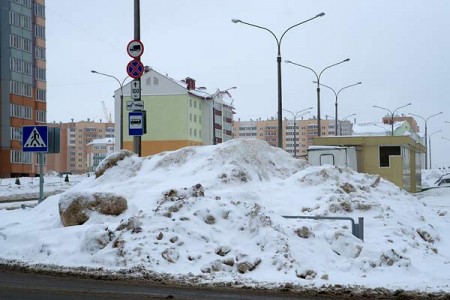 У подъездов домов в Билево накопились огромные горы снега. Фото Сергея Серебро